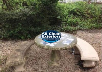 before and after cleaning of two cement benches and a table which was pressure washed in Monmouth County, NJ