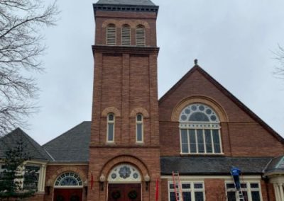 employee finishing a gutter cleaning of a church in Monmouth County, NJ