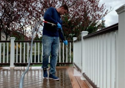 employee power washing a Trex wood deck in Monmouth County, NJ