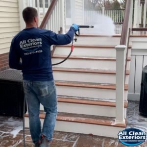 employee power washing a trex deck stairs in Monmouth County