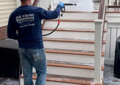 employee power washing a trex deck stairs in Monmouth County