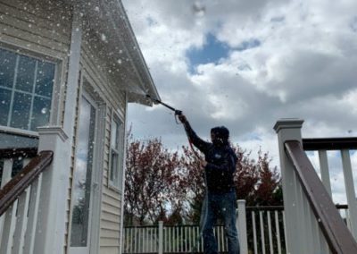 employee soft wash power washing vinyl siding in Monmouth County, NJ