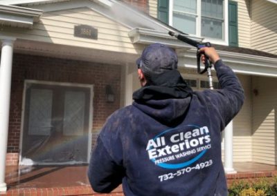 employee soft wash power washing vinyl siding in Wall Twp, NJ