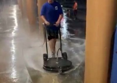 employee surface cleaning a commercial strip mall concrete sidewalk in Ocean Twp, NJ