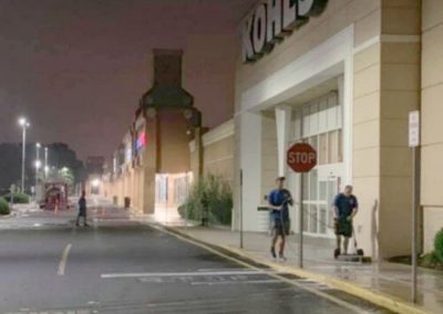 two employees power washing surface cleaning the concrete sidewalk in front of a Kohls in Monmouth County, NJ