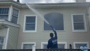 soft wash power washing a house with vinyl siding