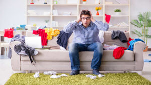 Guy in couch Decluttering a house